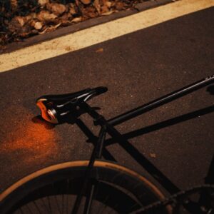 black bicycle wheel on gray concrete road